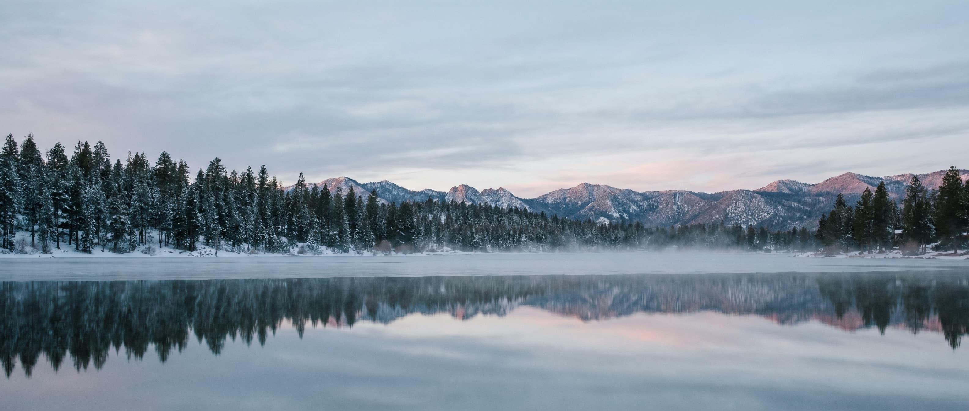 Big Bear Lake at dawn, mountains mirrored in still water